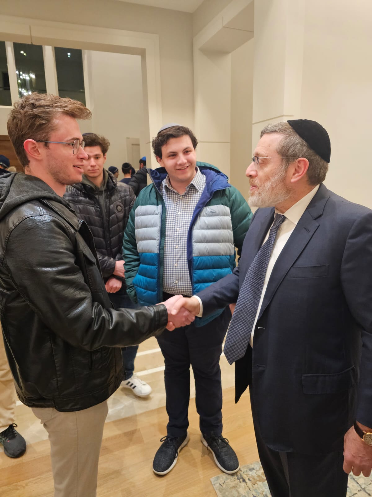 A student shaking hands with a mentor at J³ Networking Week 2025