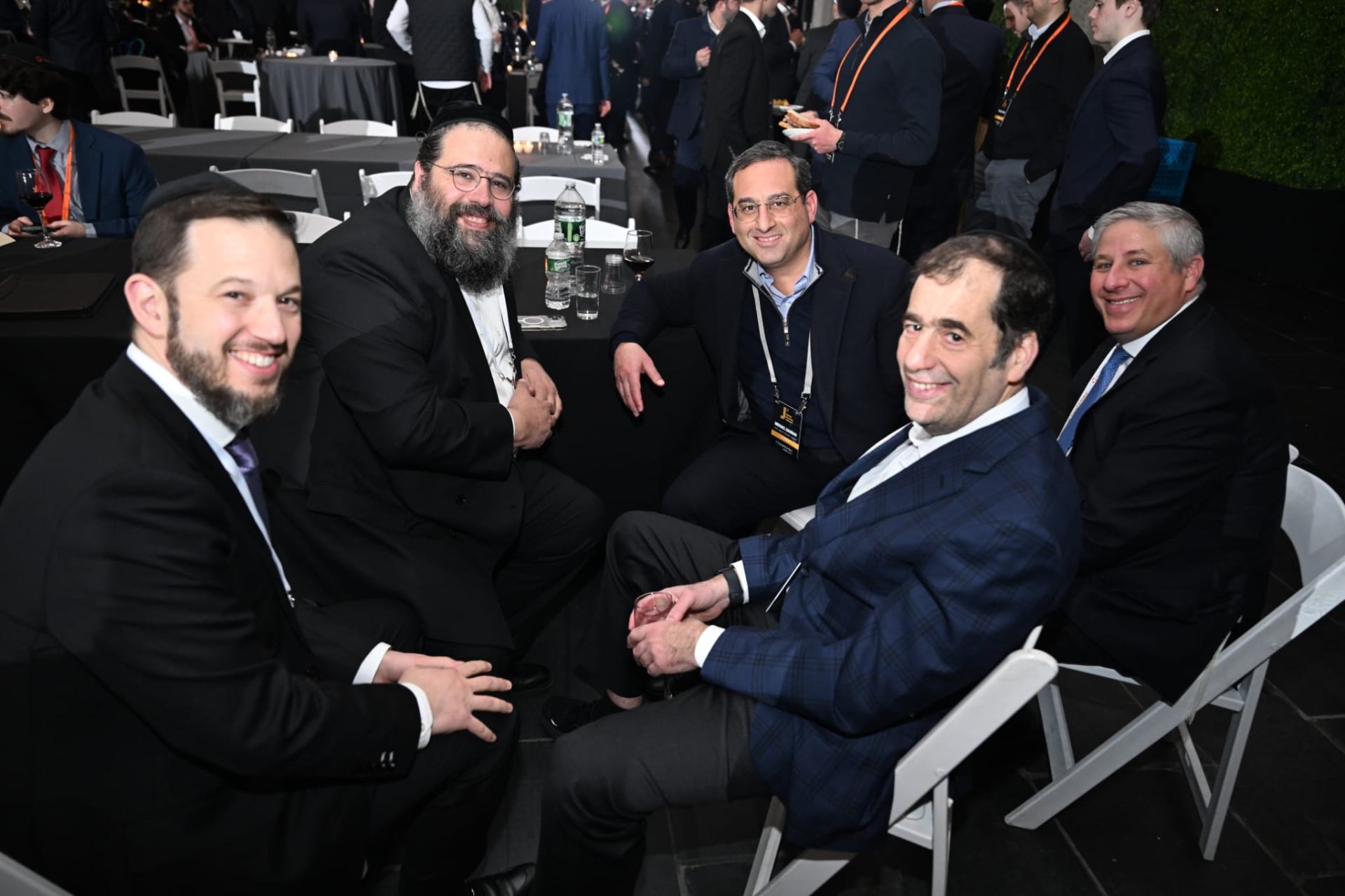 Students and mentors gathered around a Shabbos dinner table