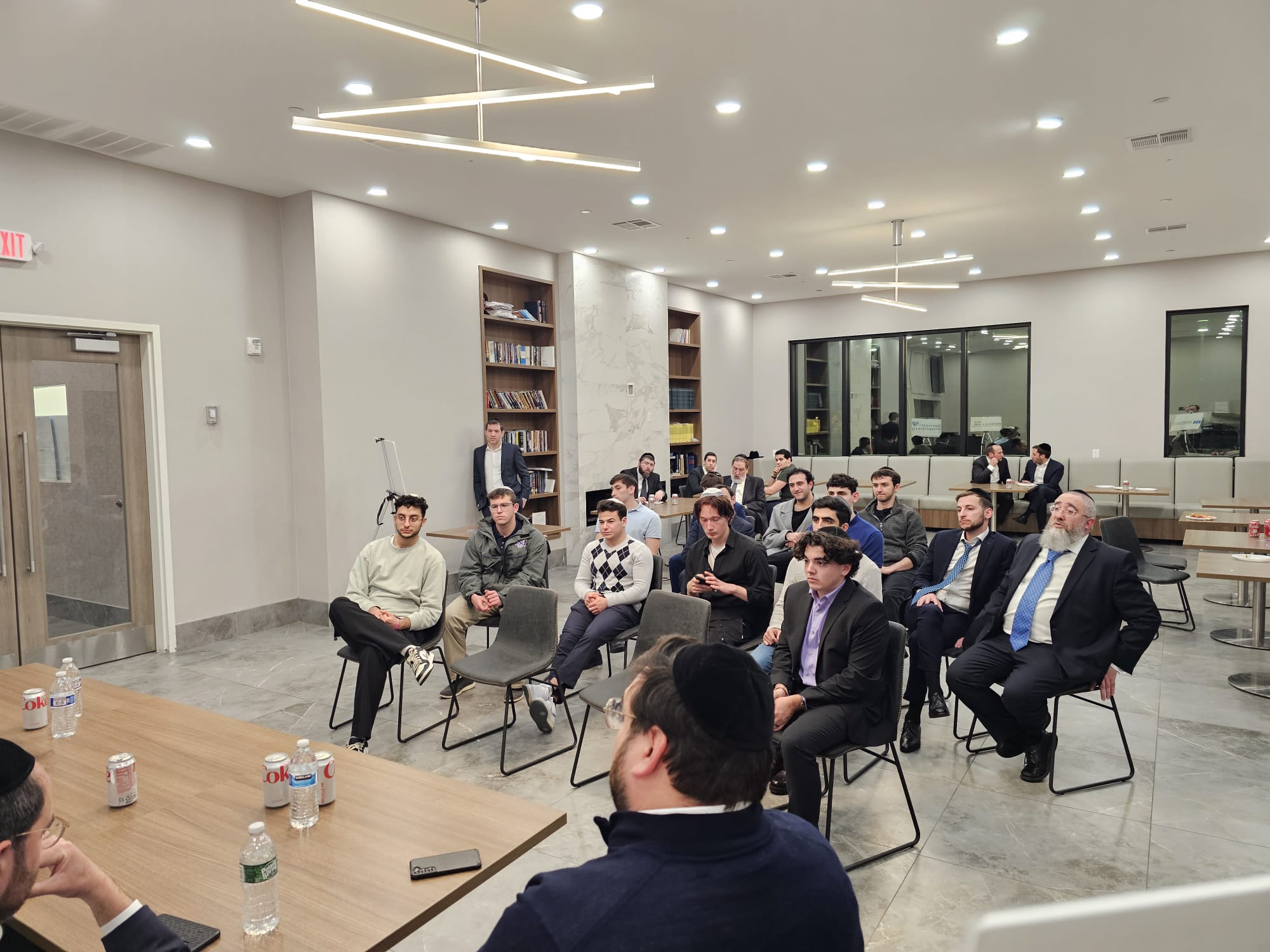 Students seated in a modern Lakewood lobby listening to a speaker