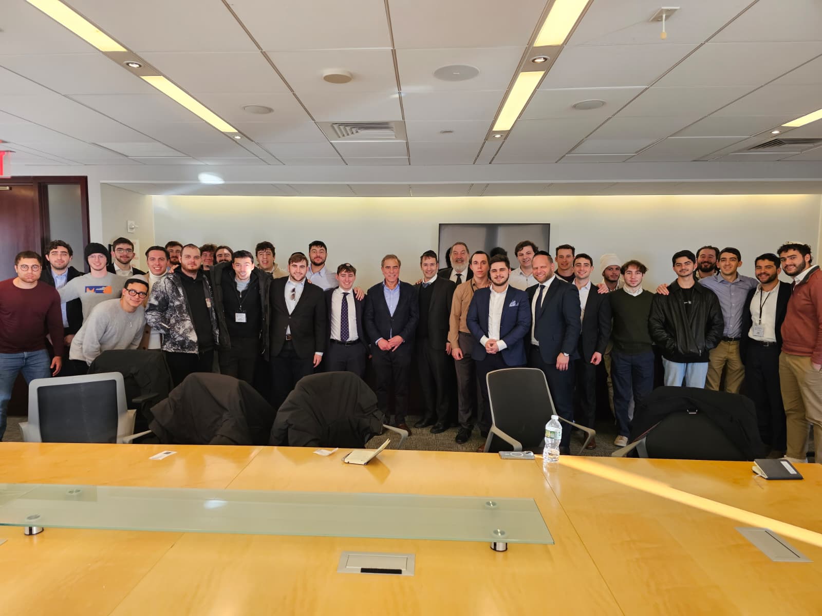 Large group of J³ Networking Week 2025 students with executives in a Manhattan boardroom