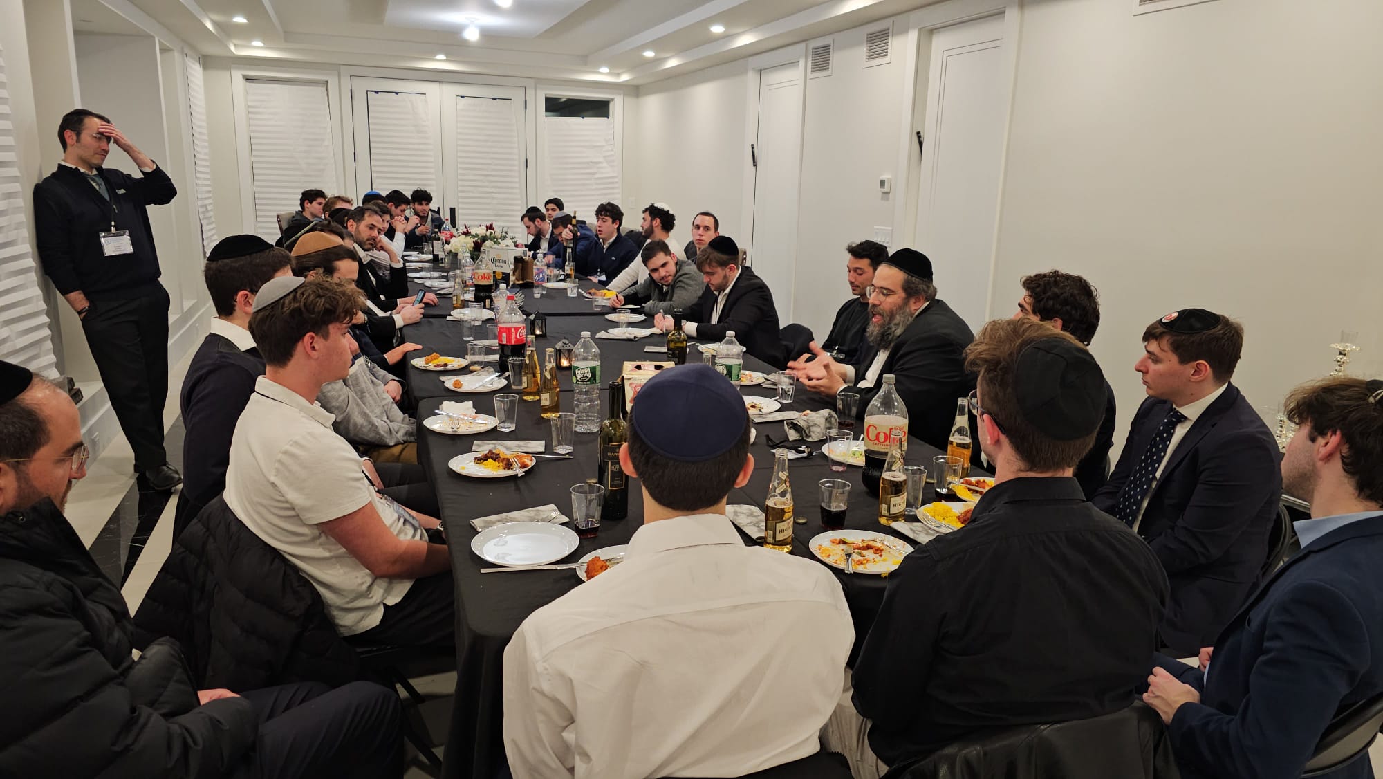A long dinner table of students and mentors at J³ Networking Week 2025