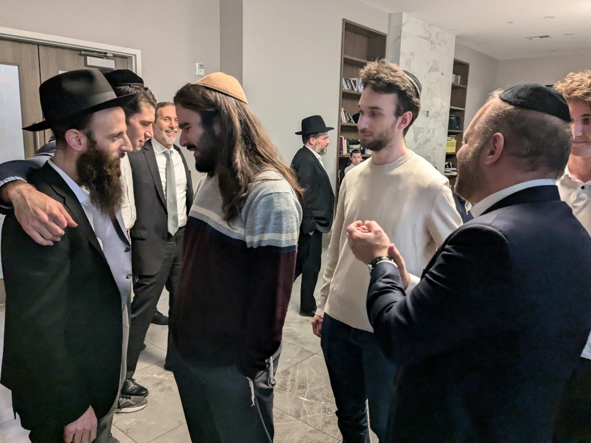 Rabbis and students in close conversation after a program