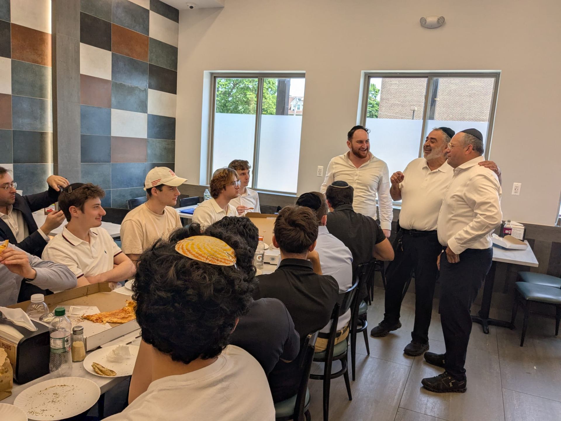 Students and rabbis sharing a pizza lunch together
