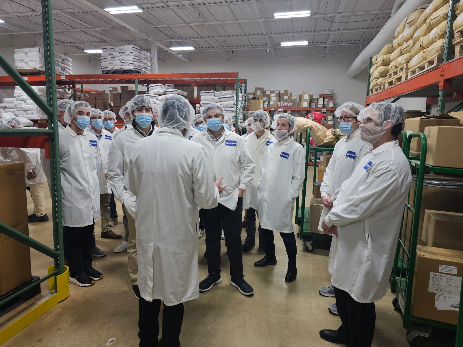 Students touring a kosher manufacturing facility in lab coats during J³ Networking Week
